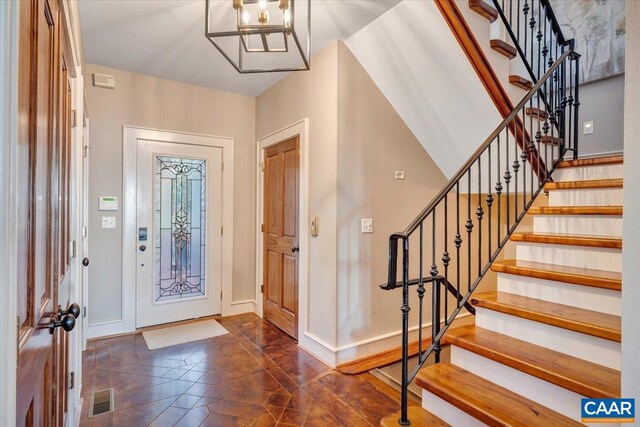 380 Blackrock Cir, Wintergreen Resort, VA 22967 - foyer entrance featuring baseboards, stairway, and a chandelier