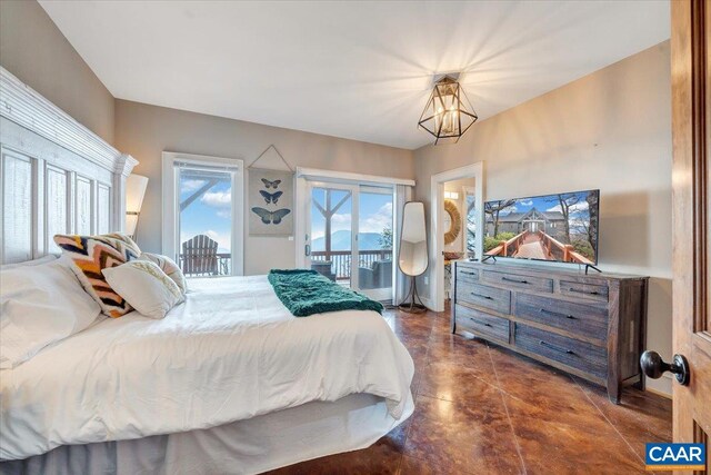 380 Blackrock Cir, Wintergreen Resort, VA 22967 - bedroom featuring finished concrete floors, a chandelier, and access to exterior