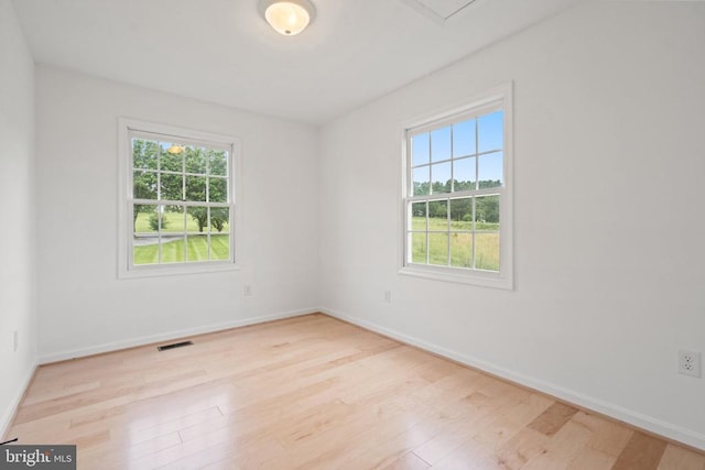 unfurnished room with wood finished floors and baseboards