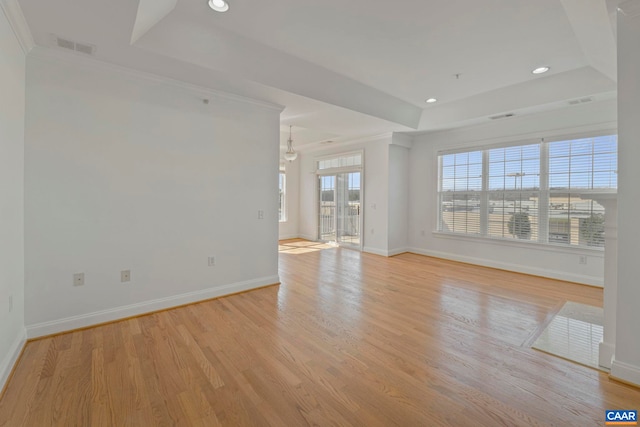 empty room with baseboards, a raised ceiling, and recessed lighting