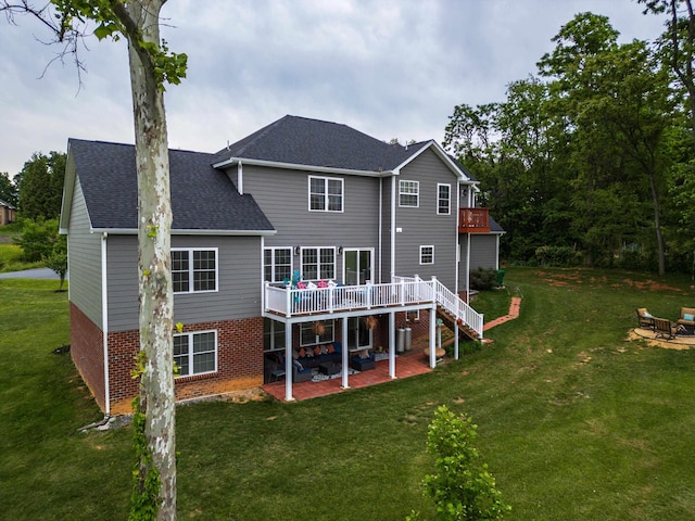 4220 Traveler Rd, Rockingham, VA 22801 - back of house with a patio area, a wooden deck, brick siding, and a yard