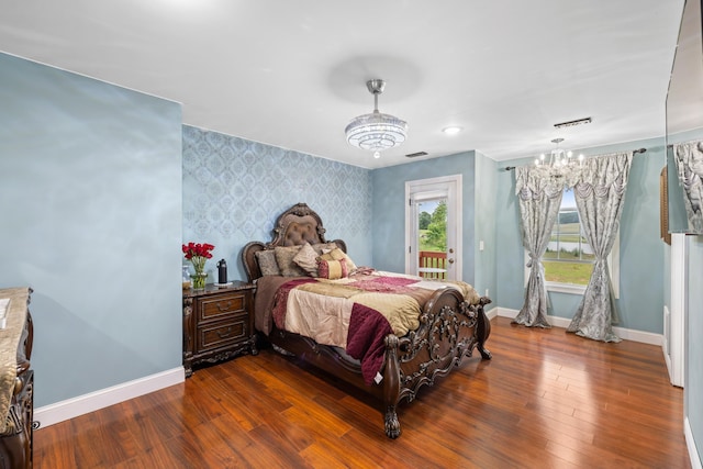 4220 Traveler Rd, Rockingham, VA 22801 - bedroom featuring wallpapered walls, a chandelier, access to exterior, baseboards, and wood finished floors