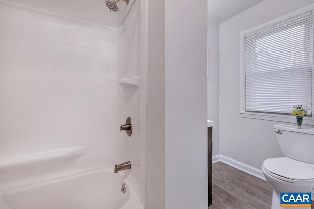 full bathroom featuring toilet, shower / washtub combination, wood finished floors, vanity, and baseboards