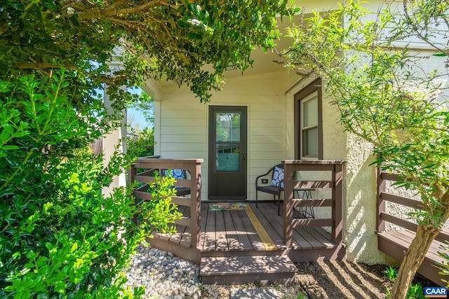 view of exterior entry featuring a deck
