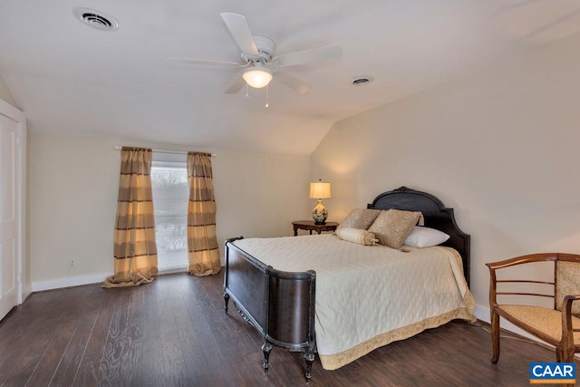 bedroom featuring lofted ceiling, a ceiling fan, baseboards, visible vents, and wood finished floors