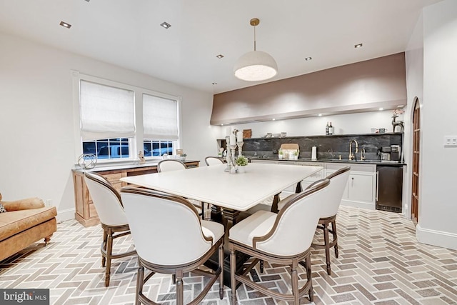  - dining area featuring brick floors, wet bar, and recessed lighting