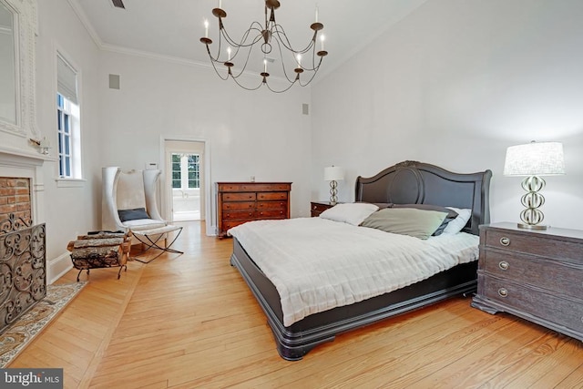  - bedroom with high vaulted ceiling, a chandelier, crown molding, and light wood finished floors