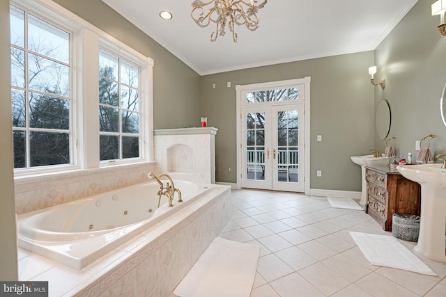  - bathroom with a jetted tub, vanity, french doors, ornamental molding, and tile patterned flooring