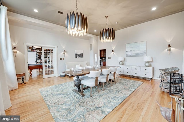  - dining area with a chandelier, wood finished floors, recessed lighting, and crown molding