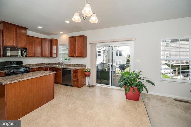 5809 Spruce Valley Dr, Fredericksburg, VA 22407 - kitchen featuring black appliances, a chandelier, pendant lighting, brown cabinetry, and a sink