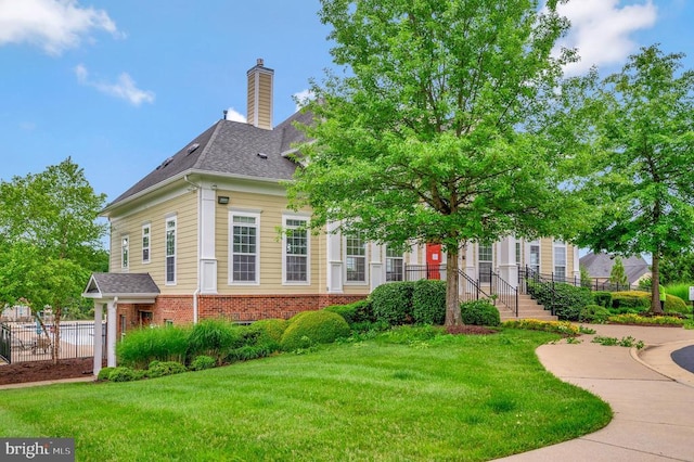 5809 Spruce Valley Dr, Fredericksburg, VA 22407 - view of front of home with brick siding, a chimney, and a shingled roof