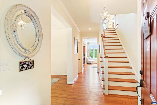 1623 Brandywine Dr, Charlottesville, VA 22901 - entrance foyer with a chandelier, baseboards, stairs, light wood finished floors, and ornamental molding