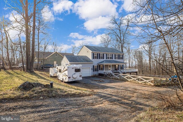 view of front of house with fence, a garage, a porch, driveway, and roof with shingles