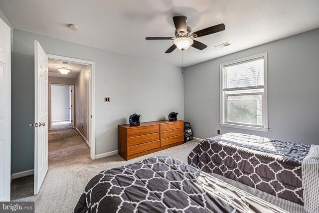 carpeted bedroom with baseboards and a ceiling fan