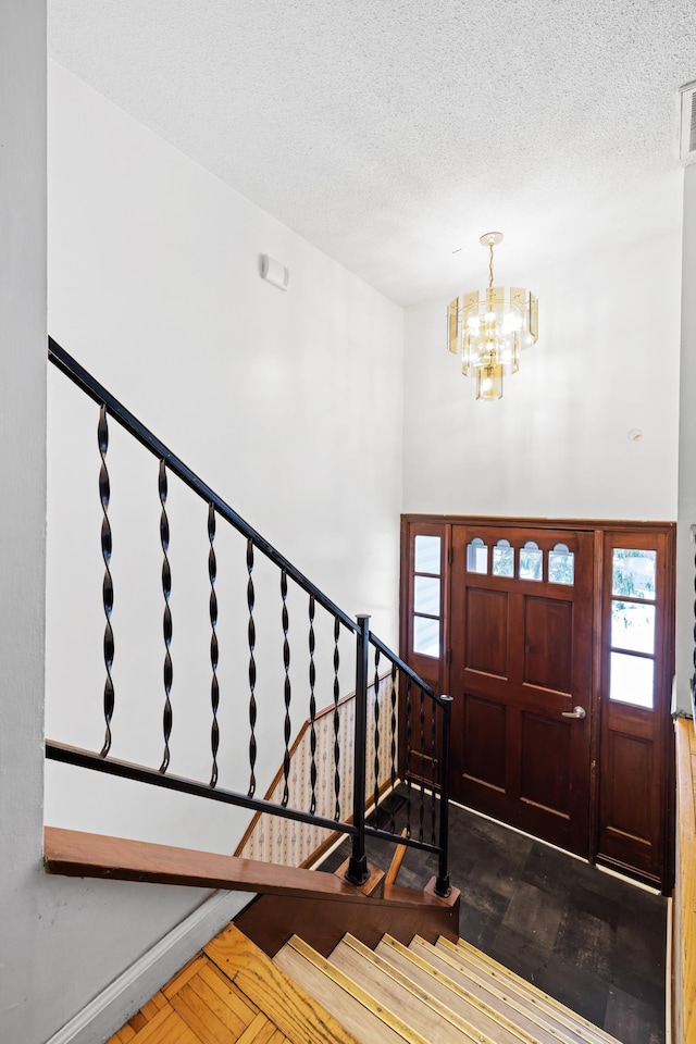 728 Foley Rd, Harrisonburg, VA 22801 - entrance foyer with a textured ceiling, a chandelier, wood finished floors, and stairway