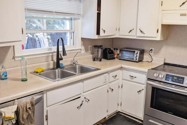 728 Foley Rd, Harrisonburg, VA 22801 - kitchen featuring white cabinets, appliances with stainless steel finishes, premium range hood, and a sink