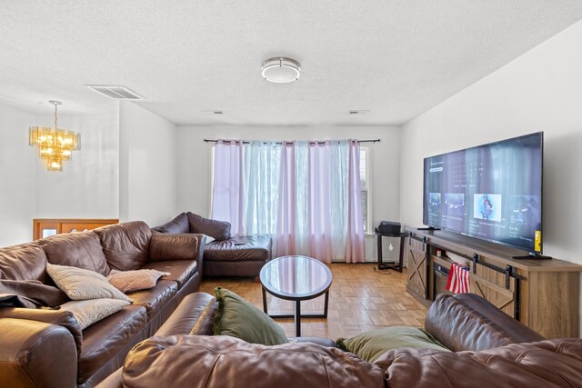 728 Foley Rd, Harrisonburg, VA 22801 - living room with a textured ceiling, visible vents, and a notable chandelier