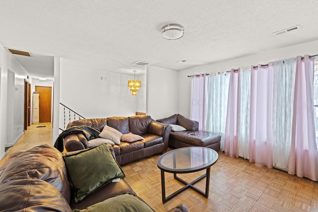 728 Foley Rd, Harrisonburg, VA 22801 - living area featuring a chandelier, a textured ceiling, and visible vents