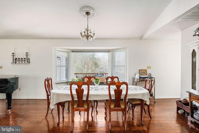 dining room featuring baseboards, a chandelier, and hardwood / wood-style flooring