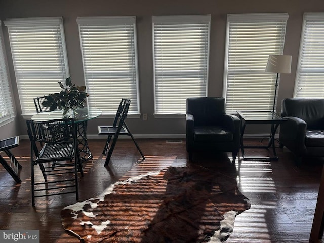  - dining space with baseboards, dark wood-style floors, and healthy amount of natural light