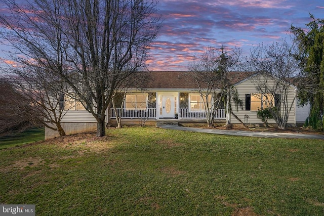  - ranch-style home with a porch and a front yard