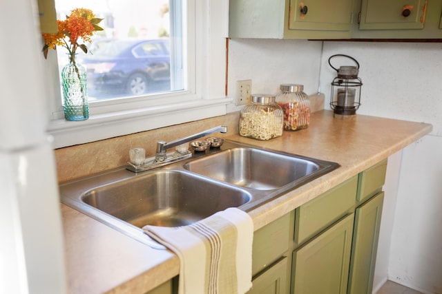 111 S High St, Edinburg, VA 22824 - kitchen with green cabinets, light countertops, and a sink