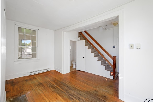 111 S High St, Edinburg, VA 22824 - unfurnished living room featuring a baseboard heating unit, stairs, baseboards, and wood-type flooring