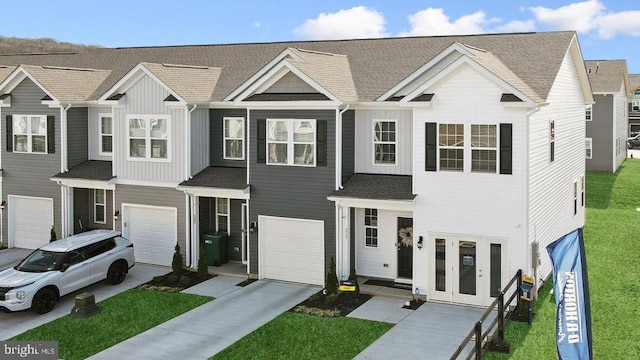 128 Rae Ct, Luray, VA 22835 - townhome / multi-family property featuring an attached garage, driveway, french doors, board and batten siding, and a front lawn