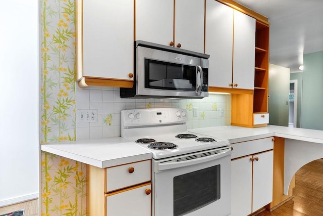 304 Burnley Dr, Staunton, VA 24401 - kitchen with white electric stove, stainless steel microwave, open shelves, light countertops, and backsplash