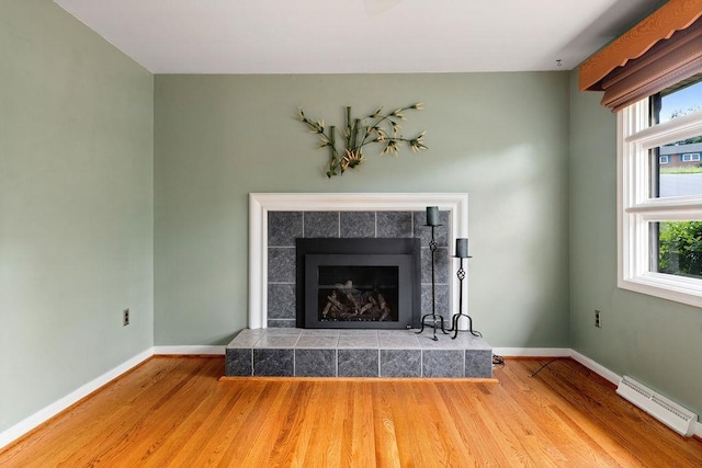 304 Burnley Dr, Staunton, VA 24401 - detailed view of a baseboard radiator, wood finished floors, and a tiled fireplace