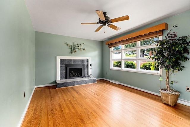 304 Burnley Dr, Staunton, VA 24401 - unfurnished living room with wood finished floors, a ceiling fan, and a tiled fireplace