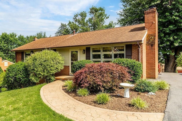 304 Burnley Dr, Staunton, VA 24401 - ranch-style house featuring brick siding, a chimney, roof with shingles, and a front yard