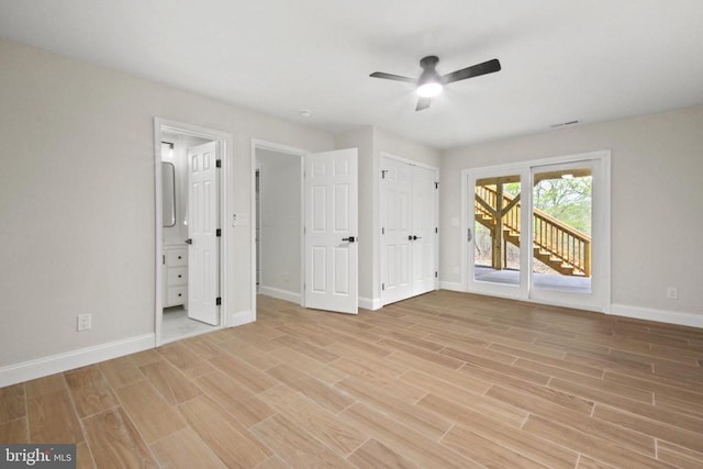unfurnished bedroom featuring access to outside, baseboards, light wood-style flooring, ensuite bathroom, and a ceiling fan