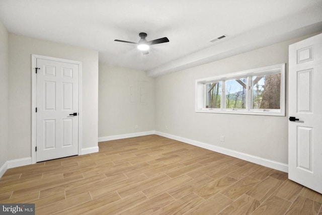 unfurnished bedroom featuring baseboards, light wood-type flooring, and a ceiling fan