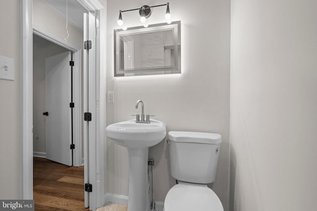 313 Burman Ln, Fredericksburg, VA 22407 - half bathroom featuring toilet, wood finished floors, and a sink