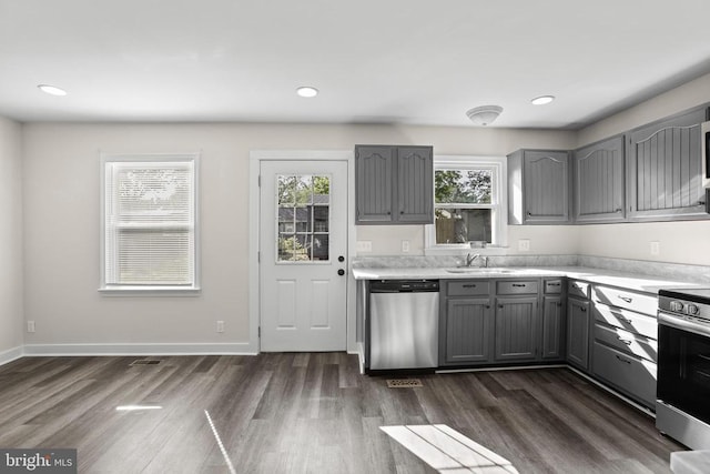 313 Burman Ln, Fredericksburg, VA 22407 - kitchen with gray cabinetry, stainless steel appliances, light countertops, dark wood finished floors, and a sink