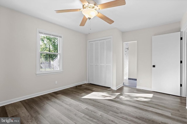 313 Burman Ln, Fredericksburg, VA 22407 - unfurnished bedroom with wood finished floors, baseboards, a closet, and ceiling fan