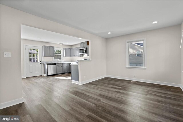 313 Burman Ln, Fredericksburg, VA 22407 - unfurnished living room with recessed lighting, dark wood-type flooring, baseboards, and a sink