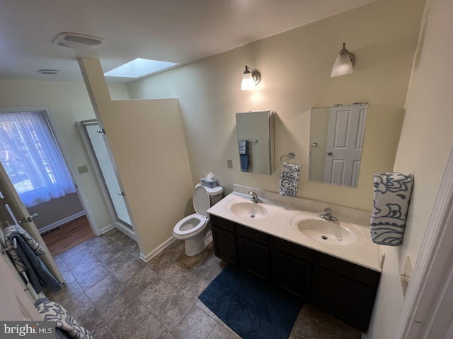 902 Eastover Pkwy, Locust Grove, VA 22508 - bathroom with a skylight, double vanity, toilet, a stall shower, and baseboards