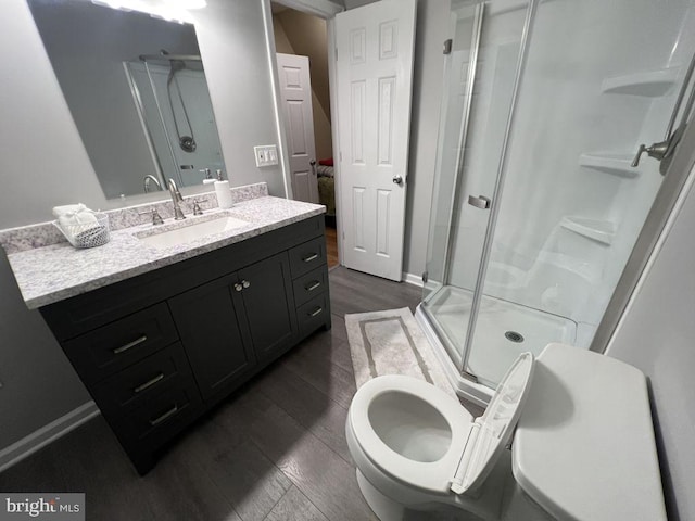 902 Eastover Pkwy, Locust Grove, VA 22508 - bathroom featuring a shower stall, wood finished floors, vanity, toilet, and baseboards