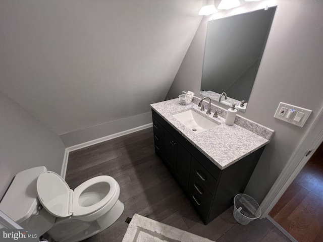 902 Eastover Pkwy, Locust Grove, VA 22508 - bathroom featuring toilet, vanity, wood finished floors, baseboards, and lofted ceiling