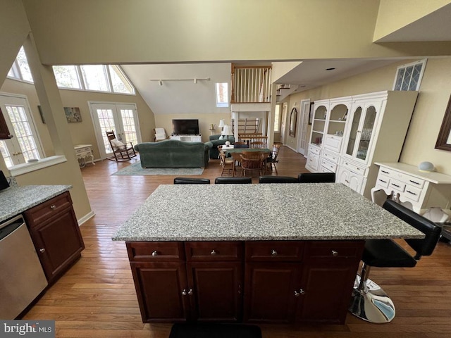 902 Eastover Pkwy, Locust Grove, VA 22508 - kitchen with stainless steel dishwasher, wood finished floors, a towering ceiling, light stone counters, and a center island