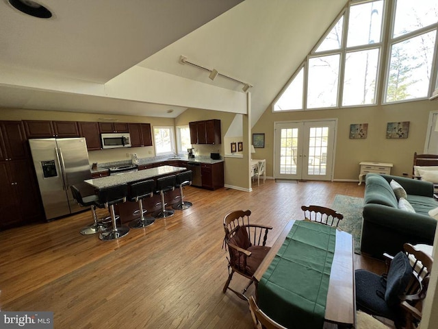 902 Eastover Pkwy, Locust Grove, VA 22508 - dining space with a high ceiling, french doors, light wood-style floors, and baseboards