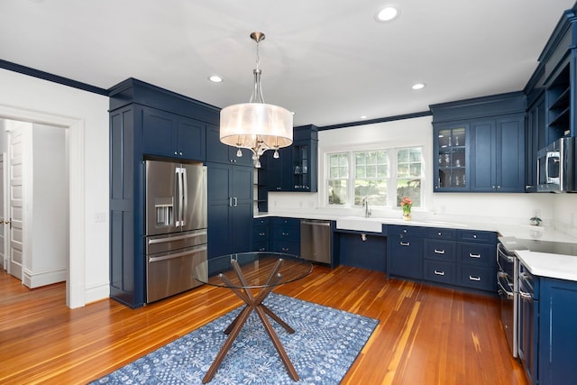 675 Beverley St E, Staunton, VA 24401 - kitchen featuring stainless steel appliances, ornamental molding, blue cabinets, dark wood-type flooring, and a sink