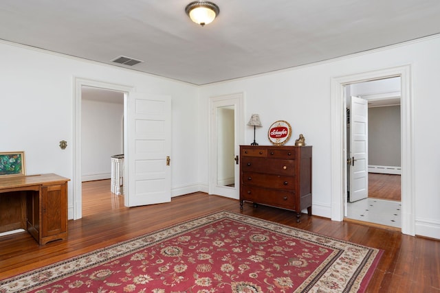 675 Beverley St E, Staunton, VA 24401 - bedroom with dark wood-type flooring, a baseboard radiator, and baseboards