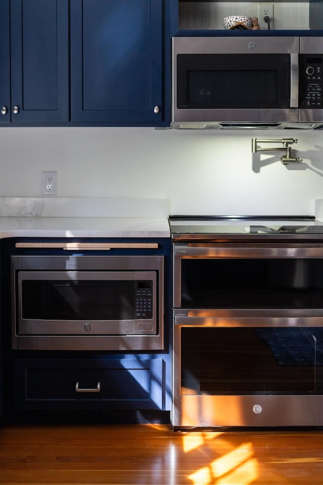 675 Beverley St E, Staunton, VA 24401 - kitchen view of appliances with stainless steel finishes, light countertops, and blue cabinets