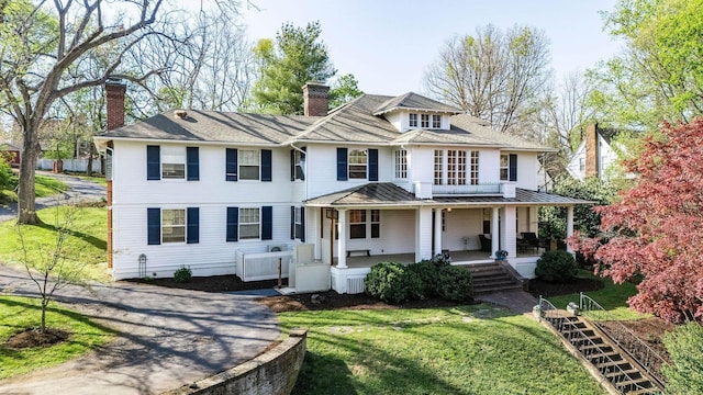 675 Beverley St E, Staunton, VA 24401 - view of front of house featuring a chimney, covered porch, a standing seam roof, a front lawn, and driveway
