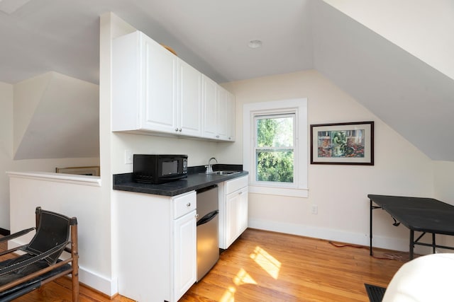 675 Beverley St E, Staunton, VA 24401 - kitchen featuring black microwave, a sink, white cabinetry, dark countertops, and light wood-style floors