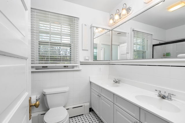 675 Beverley St E, Staunton, VA 24401 - bathroom with tile walls, toilet, a baseboard radiator, double vanity, and a shower