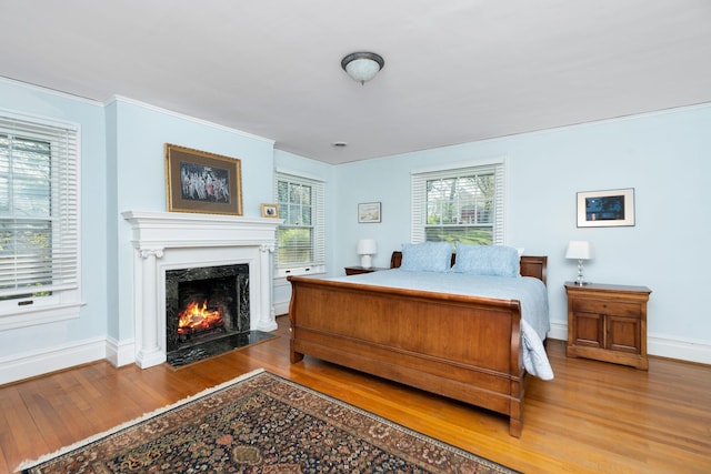 675 Beverley St E, Staunton, VA 24401 - bedroom with wood finished floors, a premium fireplace, baseboards, and crown molding